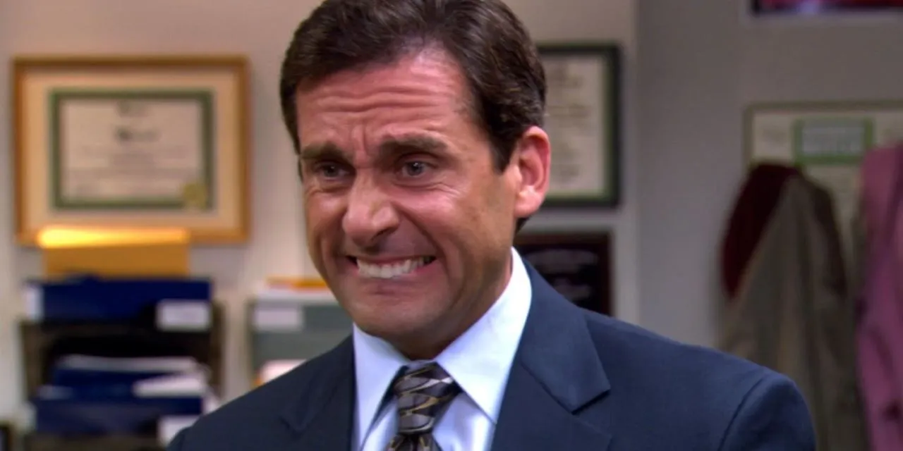 Michael Scott from The Office cringing.